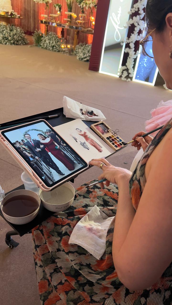 Giselle realizando pintura ao vivo em um casamento